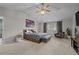 Spacious main bedroom featuring vaulted ceiling, ceiling fan, large bed and decorative city artwork at 1126 S Davenport Ct, Erie, CO 80516