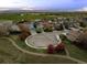Aerial view of a neighborhood featuring well-maintained homes, green spaces, and scenic mountain views at 1126 S Davenport Ct, Erie, CO 80516