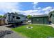 Backyard with a trailer, a well maintained lawn, a fire pit and a detached garage at 5986 Dunraven St, Golden, CO 80403