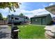 Backyard with RV parking, a small detached garage, and a green lawn with a fire pit and grill at 5986 Dunraven St, Golden, CO 80403