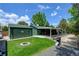 Spacious backyard featuring a covered patio, garage, fire pit, and well-maintained lawn at 5986 Dunraven St, Golden, CO 80403