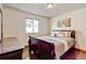 Bedroom with hardwood floors, a sleigh bed, and a bright window at 5986 Dunraven St, Golden, CO 80403