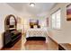 Cozy bedroom features hardwood floors, modern decor, and natural light from the window at 5986 Dunraven St, Golden, CO 80403