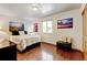 Comfortable bedroom with hardwood floors, a bright window, and charming decor at 5986 Dunraven St, Golden, CO 80403