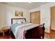 Bedroom featuring hardwood floors, a bed, and a sliding closet door at 5986 Dunraven St, Golden, CO 80403