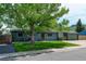 Quaint single-story home featuring a lush green lawn, charming curb appeal, and an attached garage at 5986 Dunraven St, Golden, CO 80403