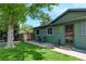Well-maintained green home with shuttered windows, cozy seating, and a welcoming front porch at 5986 Dunraven St, Golden, CO 80403