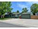 Exterior view of an inviting home with a well-maintained lawn, and a detached garage at 5986 Dunraven St, Golden, CO 80403
