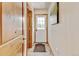Bright hallway with white door and a stylish flooring at 5986 Dunraven St, Golden, CO 80403