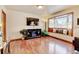 Inviting living room featuring a fireplace, large windows, and hardwood floors, offering warmth and natural light at 5986 Dunraven St, Golden, CO 80403