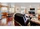 Open-concept living space with hardwood floors, kitchen island, and a comfortable living room at 5986 Dunraven St, Golden, CO 80403