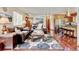 Warm and inviting living room with hardwood floors, comfortable seating, and a seamless transition to the kitchen at 5986 Dunraven St, Golden, CO 80403