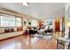 Spacious living room showcasing hardwood floors, a cozy window seat, and comfortable seating arrangements at 5986 Dunraven St, Golden, CO 80403