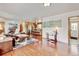 Bright, open-concept living space with hardwood floors, seamlessly connecting to the kitchen for easy entertaining at 5986 Dunraven St, Golden, CO 80403