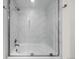 Stylish bathroom featuring a tiled shower and tub combination with glass doors at 1616 S Broadway # 206, Denver, CO 80210