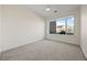Neutral bedroom with a large window overlooking the outdoors and plush carpeting at 1616 S Broadway # 206, Denver, CO 80210