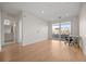 Bright bedroom with hardwood floors, access to a balcony, and an ensuite bathroom at 1616 S Broadway # 206, Denver, CO 80210