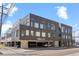 Contemporary apartment building showcasing modern architecture, dark brick, and covered parking garage at 1616 S Broadway # 206, Denver, CO 80210