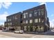 Modern brick apartment building showcasing contemporary design with large windows and street parking at 1616 S Broadway # 206, Denver, CO 80210