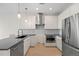 Modern kitchen with stainless steel appliances, gray countertops, and tile backsplash at 1616 S Broadway # 206, Denver, CO 80210
