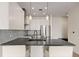 Contemporary kitchen with white cabinetry, stainless steel appliances, and pendant lighting at 1616 S Broadway # 206, Denver, CO 80210