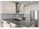 Bright kitchen featuring an island with seating, stainless steel appliances, and modern lighting at 1616 S Broadway # 206, Denver, CO 80210