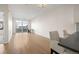 Open-concept living room with hardwood floors, access to a balcony, and ample natural light at 1616 S Broadway # 206, Denver, CO 80210