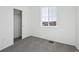 A bright bedroom with gray carpet, a window, and a closet with sliding doors at 1238 Penner Dr, Erie, CO 80026