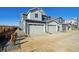 View of new construction townhomes with attached garages and modern farmhouse style exteriors at 1238 Penner Dr, Erie, CO 80026