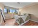 This bedroom features a cozy bed and large windows providing plenty of natural light with a beautiful view at 1196 N Grant St # 407, Denver, CO 80203