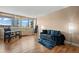 A bright, modern living room with hardwood floors, large windows, and contemporary decor at 1196 N Grant St # 407, Denver, CO 80203