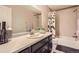 Bright bathroom featuring a modern vanity, sleek fixtures, and a shower-tub combo at 1519 S Dayton St, Denver, CO 80247