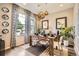 Modern dining area with stylish light fixtures, a wooden table, and ample natural light at 1519 S Dayton St, Denver, CO 80247