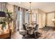 Stylish dining area boasts a modern light fixture, hardwood floors, and elegant decor at 1519 S Dayton St, Denver, CO 80247