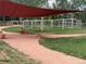 This image shows a community dog park with a shaded seating area at 1519 S Dayton St, Denver, CO 80247