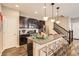 Well-appointed kitchen featuring stainless steel appliances, granite countertops, and a breakfast bar at 1519 S Dayton St, Denver, CO 80247