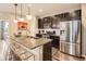 Modern kitchen with stainless steel appliances, granite countertops, and a breakfast bar at 1519 S Dayton St, Denver, CO 80247