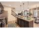 Spacious kitchen with a large island, stainless steel appliances, and an open layout at 1519 S Dayton St, Denver, CO 80247