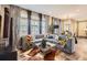 Open-concept living room area with a large sofa, stylish decor, and ample natural light at 1519 S Dayton St, Denver, CO 80247