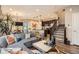 Bright and airy living space with hardwood floors, a comfortable sofa, and staircase access at 1519 S Dayton St, Denver, CO 80247