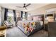 Spacious main bedroom featuring large windows and a ceiling fan for optimal light and comfort at 1519 S Dayton St, Denver, CO 80247