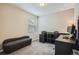 Home office with a sleek black desk, modern furnishings, and a comfortable sitting area at 1519 S Dayton St, Denver, CO 80247