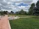 Community park featuring walking paths, mature trees, and open green space at 1519 S Dayton St, Denver, CO 80247