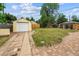 Large backyard with detached garage and brick accents, perfect for outdoor enjoyment and entertainment at 2731 S Pearl St, Englewood, CO 80113