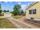 Private backyard featuring a one car garage, a brick driveway, and lush lawn at 2731 S Pearl St, Englewood, CO 80113