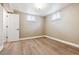 Finished basement featuring vinyl floors, neutral paint, and two windows at 2731 S Pearl St, Englewood, CO 80113