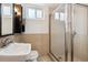 Basement bathroom with shower, sink, and neutral tiling at 2731 S Pearl St, Englewood, CO 80113
