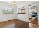 Dining area featuring hardwood floors, a pass-through to the kitchen, and a large window at 2731 S Pearl St, Englewood, CO 80113
