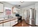 Cozy kitchen featuring stainless steel appliances, white cabinets, and hardwood floors at 2731 S Pearl St, Englewood, CO 80113