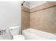 Bathroom features white tile walls with strip accent, bathtub and shower with white tile at 2101 S Victor St # C, Aurora, CO 80014